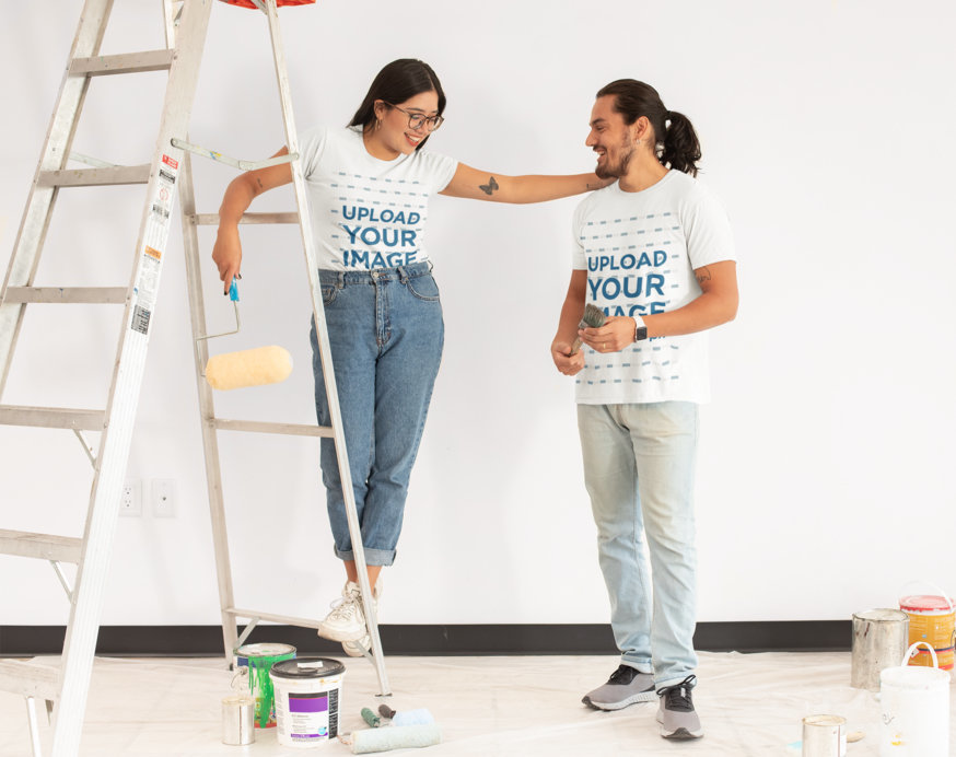 T-Shirt Mockup Featuring a Man and a Woman Painting a Wall