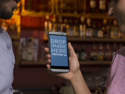 HTC One Mockup Template Featuring a Couple at a Bar