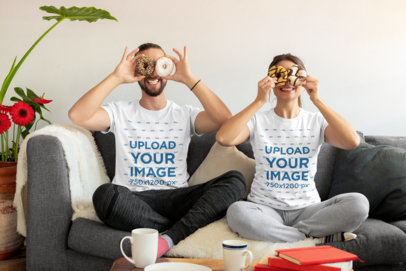 T-Shirt Mockup Featuring a Fun Couple Putting Donuts on Their Eyes m1106