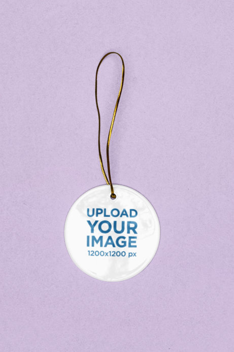 Christmas-Themed Mockup of a Rounded Ornament With a Gold Thread