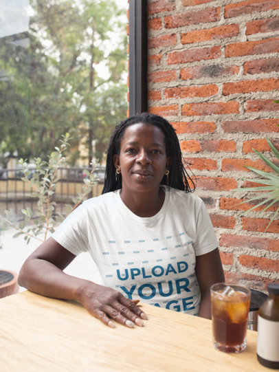Mockup of a Senior Woman Wearing a T-Shirt at a Cafe