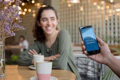Space Gray iPhone 8 Plus Mockup Featuring a Man with a Woman at a Coffee Shop