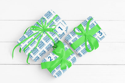 Sublimated Wrapping Paper Mockup Featuring Three Gifts Lying on a White Wooden Surface