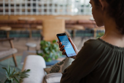 Mockup of a Woman Using a Space Gray iPhone 8 Plus at a Cafe