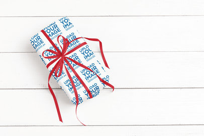 Mockup of a Present Covered in Wrapping Paper Featuring a White Wooden Surface m35549 r-el2