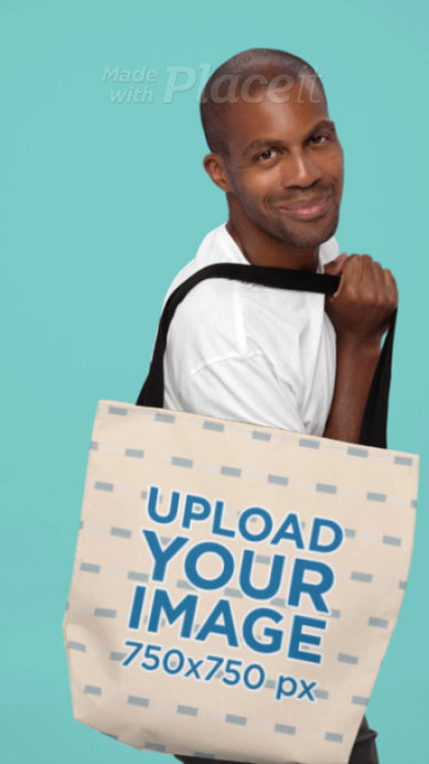 Video of a Smiling Man Carrying a Sublimated Tote Bag in a Studio