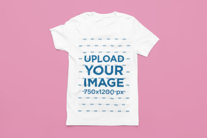 Mockup of a Bella Canvas T-Shirt Flat Laid over a Customizable Surface