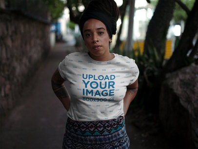 Sublimated Round Neck Tee Mockup of a Woman with Locs on the Street