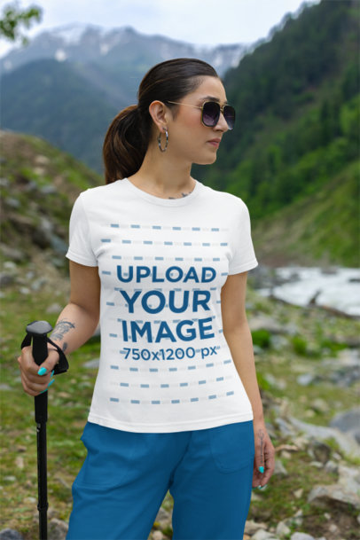 Gildan T-Shirt Mockup Featuring a Woman on a Mountain with a Hiking Stick
