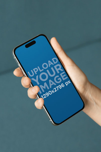 Mockup of a Woman's Hand Holding an iPhone 15 Pro Max
