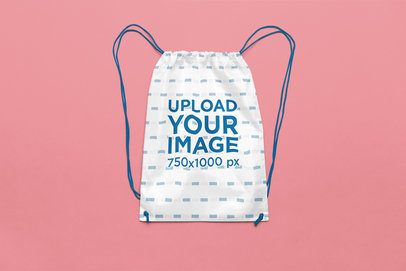 Mockup of a Sublimated Drawstring Bag Lying on a Colorful Background m36711