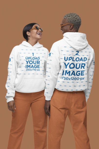 Gildan Pullover Hoodie Mockup Featuring a Cheerful Woman and Man Standing in a Studio