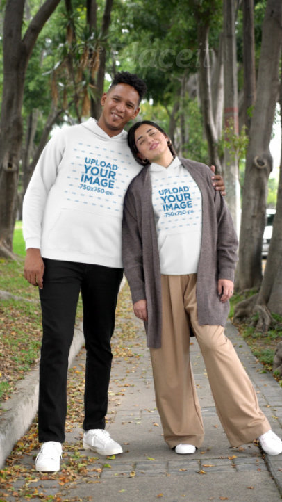 Gildan Hoodie Video of a Smiling Couple Holding Hands and Walking in the Park 7477v