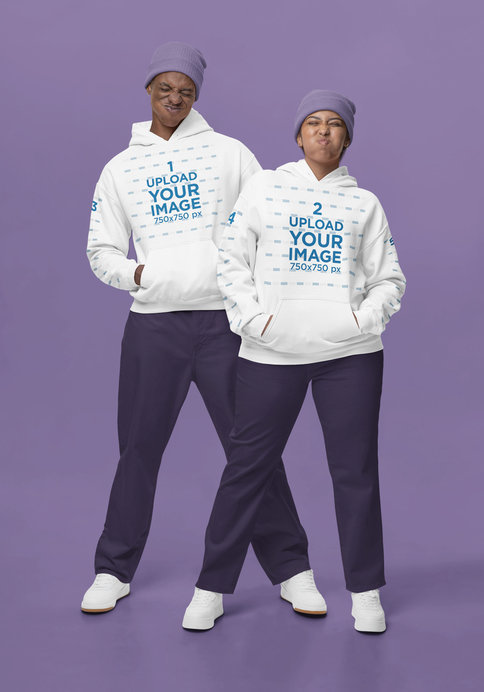 Gildan Hoodie Mockup Featuring a Man and a Woman in Gender Neutral Outfits