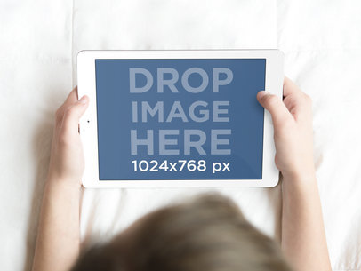 Teenage Girl Using White iPad in Bed Mockup Template