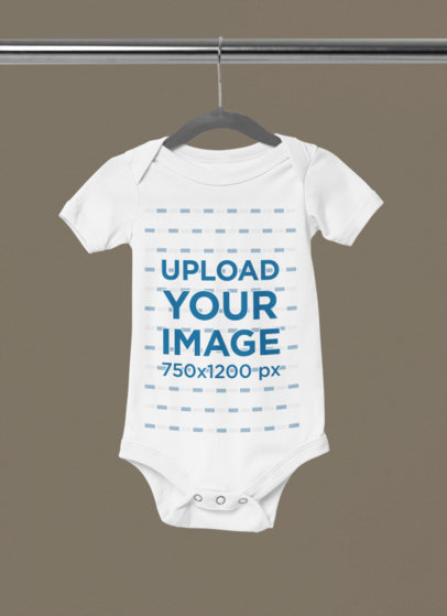 Mockup of a Short-Sleeve Baby Onesie Placed on a Hanger m35319