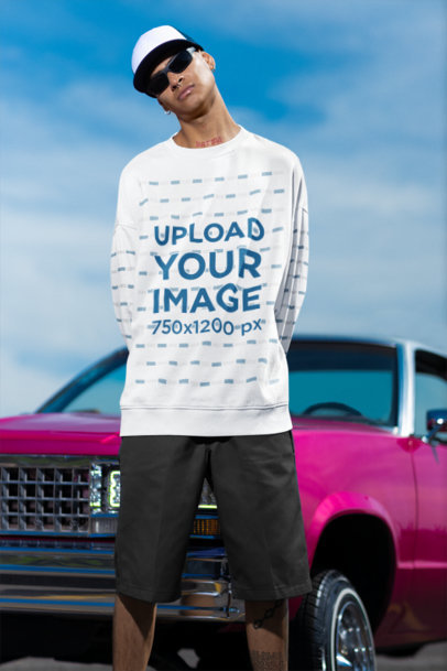 Crewneck Sweatshirt Mockup Featuring a Tattooed Man Posing Against a Pink Car