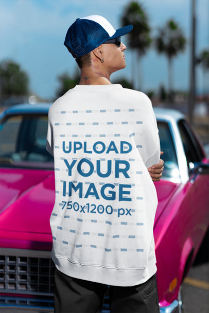 Back-View Mockup Featuring a Man Wearing an Oversized Sweatshirt by a Muscle Car m36812