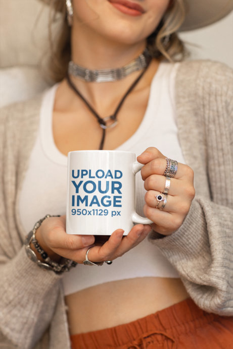 Mockup of a Woman in a Boho Outfit Holding an 11 oz Coffee Mug
