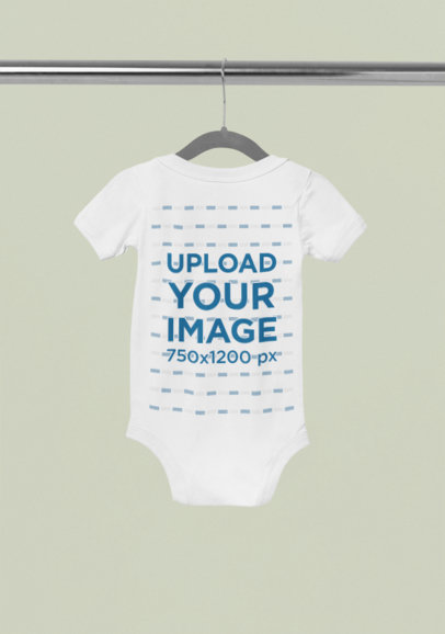 Back-View Mockup of a Baby Short-Sleeve Onesie Placed on a Hanger