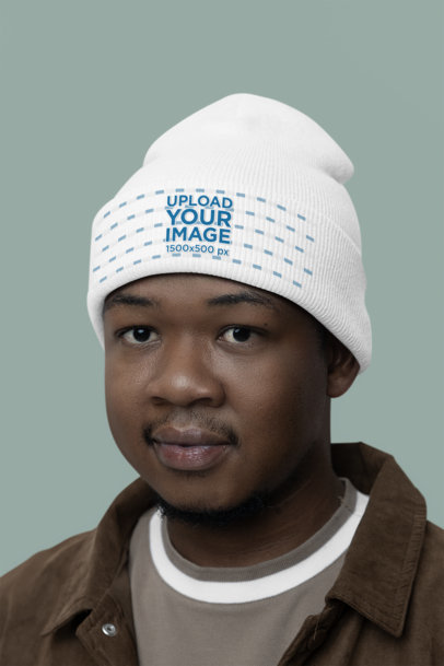 Mockup Featuring a Man Wearing a Yupoong Beanie in a Studio m35469