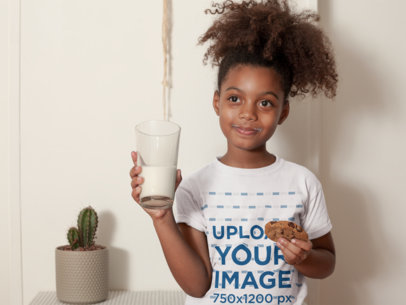 T-Shirt Mockup of a Child Having a Glass of Milk and a Cookie