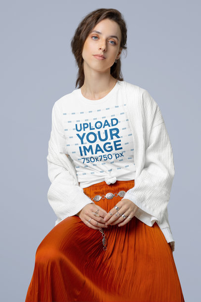 Mockup of a Woman Wearing a Crewneck Tee and a Boho-Inspired Outfit in a Studio