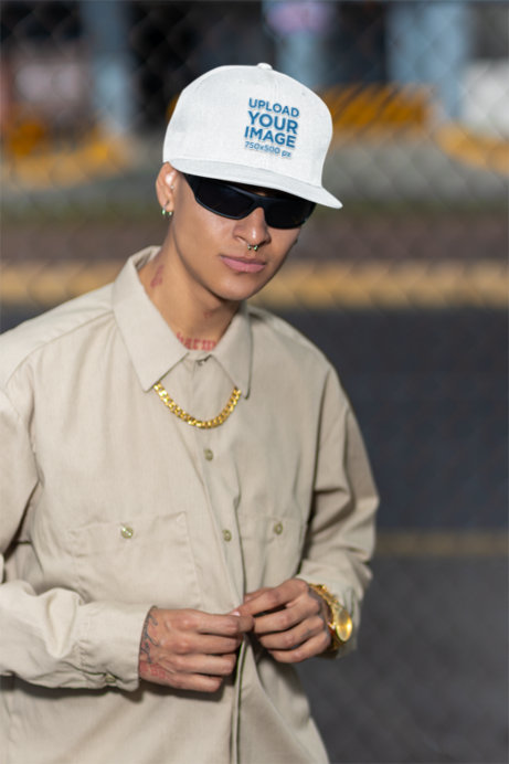 Placeit - Snapback Hat Mockup Featuring a Tattooed Man With a Serious Look
