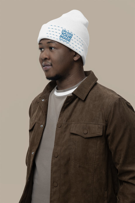 Mockup of a Man Wearing a Yupoong Beanie in a Studio