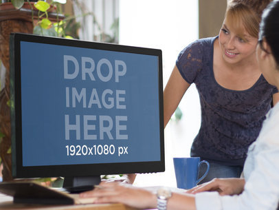 Desktop PC Mockup Featuring Two Female Coworkers 