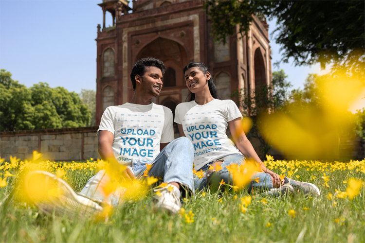 Gildan T-Shirt Mockup of a Happy Man and Woman Sitting on the Grass