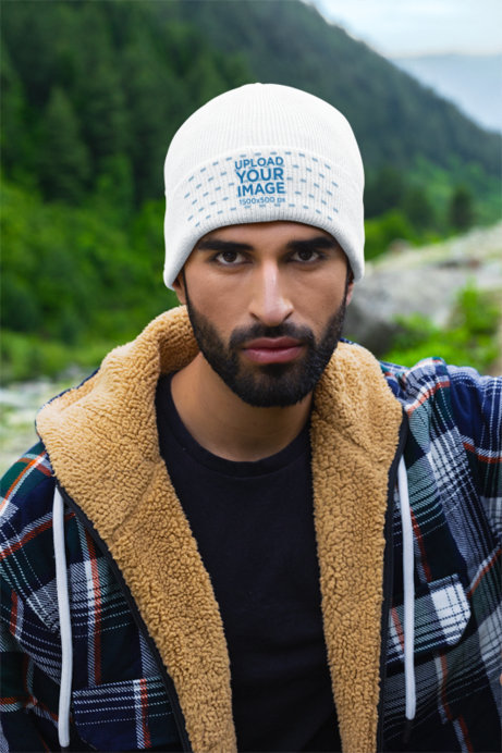 Beanie Mockup Featuring a Serious Bearded Man in the Mountains