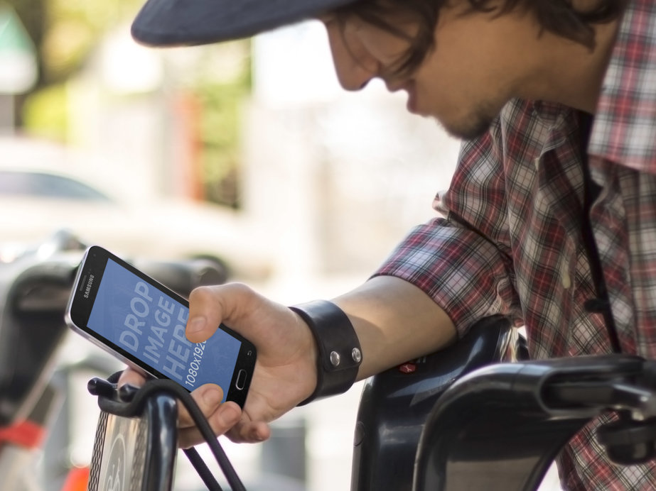 Guy Using a Public Bike With Samsung Galaxy S5 Mockup 