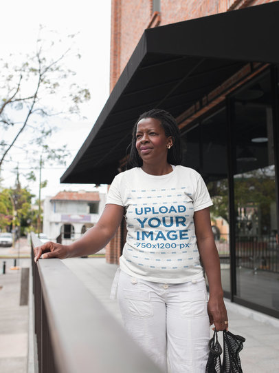 Mockup of a Woman with Braids Wearing a T-Shirt while on the Street