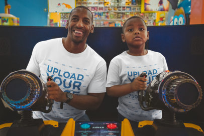 T-Shirt Mockup of a Father and Son Playing at the Arcade
