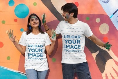 Scott International T-Shirt Mockup of a Happy Man and Woman in Painted Hands for Holi