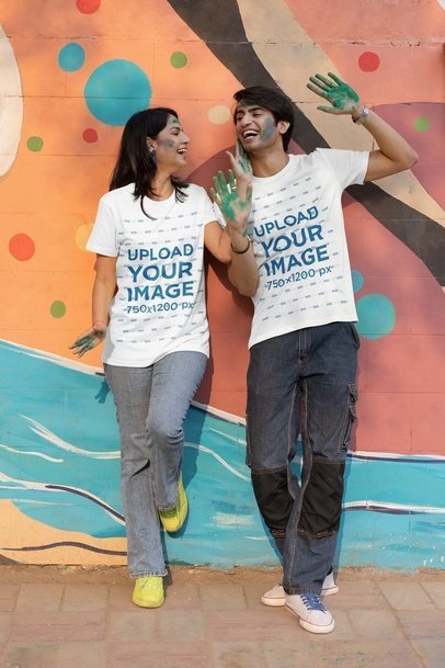 Scott International T-Shirt Mockup Featuring a Smiling Man and Woman Getting Ready for Holi