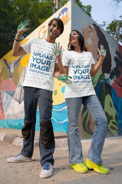 Holi-Themed Mockup of a Happy Man and Woman in Painted Hands Wearing Scott International T-Shirts