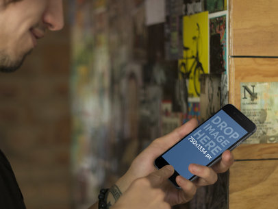 Hip Young Man Using Black iPhone 6 Mockup Template