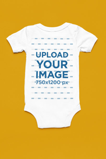 Back-View Mockup of a Onesie Placed over a Solid Surface