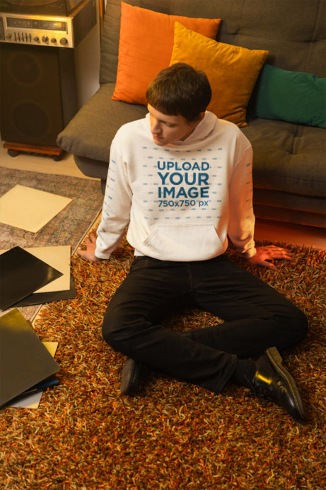 Gildan Hoodie Mockup Featuring a Man Sitting on the Floor With Some Music Records