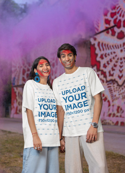 Holi-Themed Mockup Featuring a Happy Couple Wearing Matching Blinkstore T-Shirts