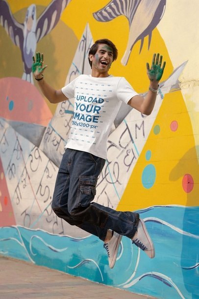 Scott International T-Shirt Mockup of a Cheerful Man Jumping in a Holi Celebration m37221