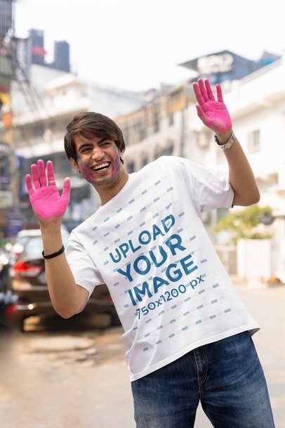 T-Shirt Mockup of a Smiling Man Celebrating the Holi Festival with Color Powder on His Hands m37222