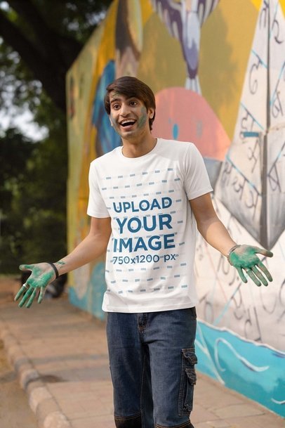Scott International T-Shirt Mockup Featuring a Man With His Hands in Green Paint for Holi Fest