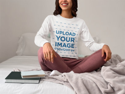 Bella Canvas Long-Sleeve Tee Mockup Featuring a Smiling Woman Sitting on a Bed