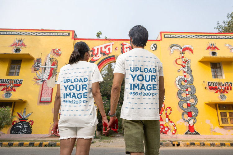 Back-View Mockup of a Man and a Woman Wearing Matching T-Shirts for the Holi Festival
