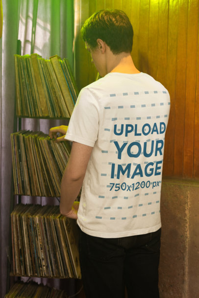 Back-View Bella Canvas T-Shirt Mockup Featuring a Man Shopping in a Music Store
