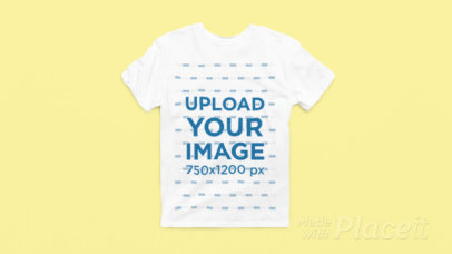 Video of a Round-Neck Gildan T-Shirt Lying Over a Colorful Surface