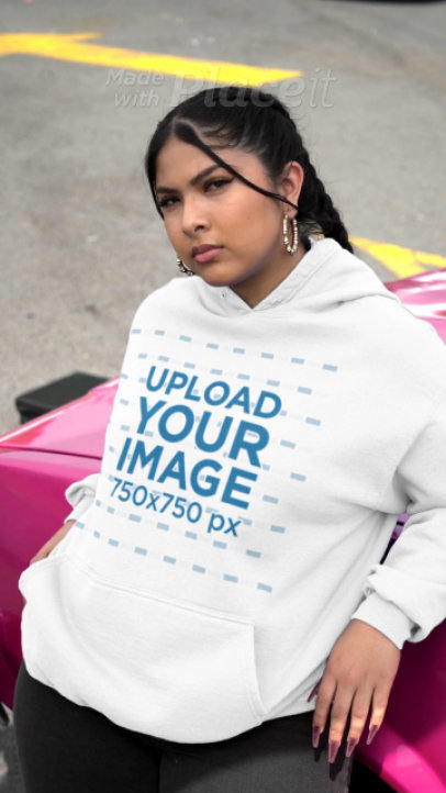 Gildan Pullover Hoodie Video of a Serious Woman Leaning Against a Car